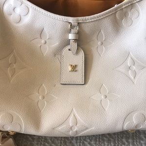 Louis Vuitton CarryAll PM Cre’me beige Monogram Empreinte Embossed Leather.